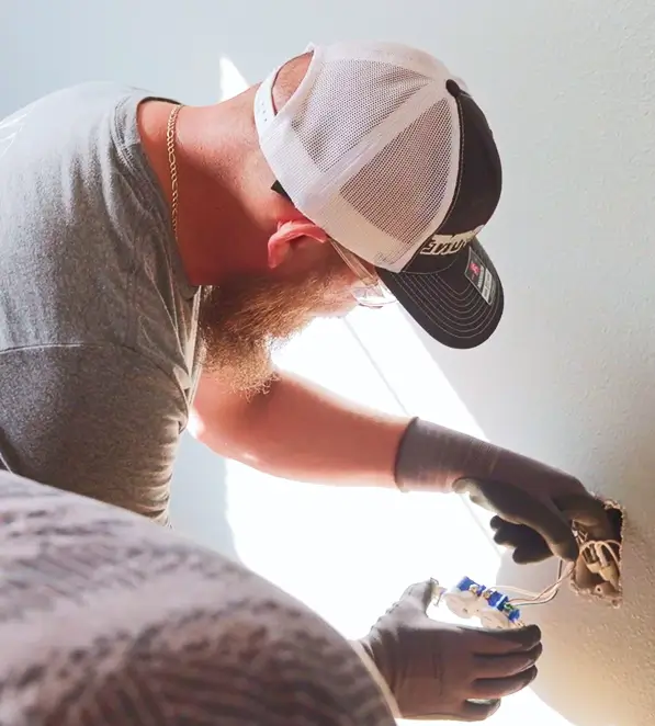 A-One electrician wiring a wall receptacle